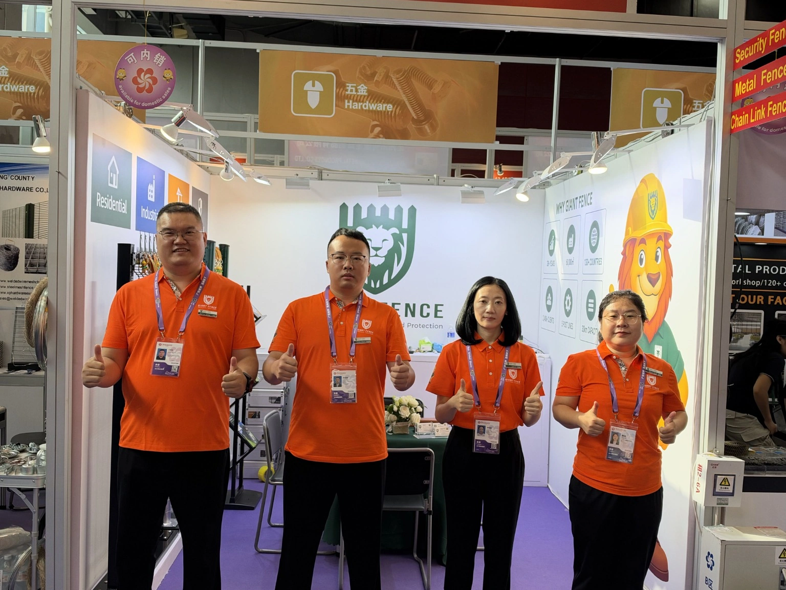 Four team members in orange uniforms at the 140th Canton Fair.