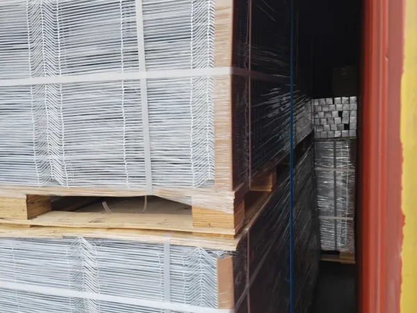 Stacked 3D welded mesh fence packs on wooden pallets