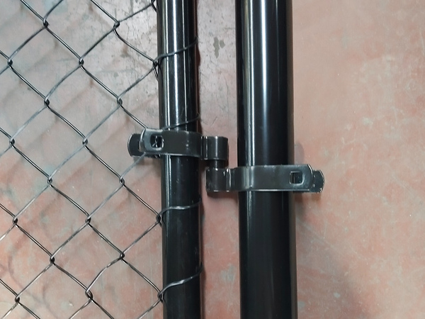 Detailed shot of hinge fittings for black powder coated chain link fence.