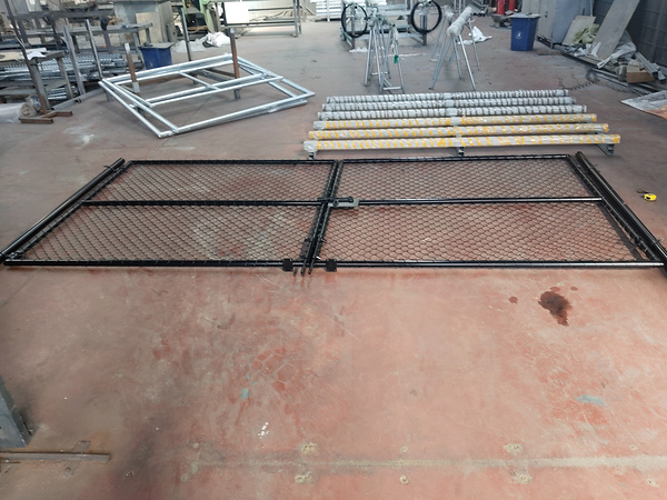 Finished chain link fence double gate panels laid out in our workshop.