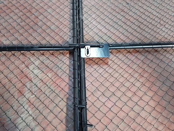 Close-up view of the locking hardware on our chain link fence double gate.