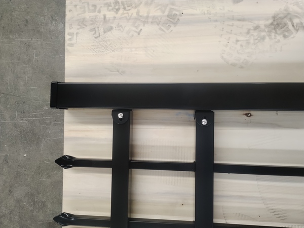 Spear top picket details of powder coated steel tubular fence panel.