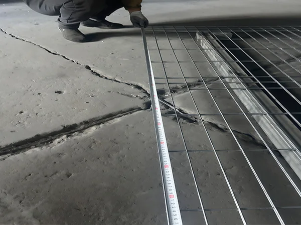 A QC worker is measuring the fence height of 3D fence.