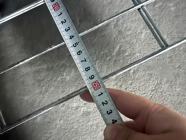 A QC worker is measuring the fence width of 3D fence.