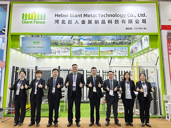 The group takes photo at the front of exhibition booth of 137th canton fair.