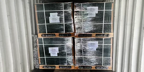 Several wooden pallets of airport fence panels in the container.