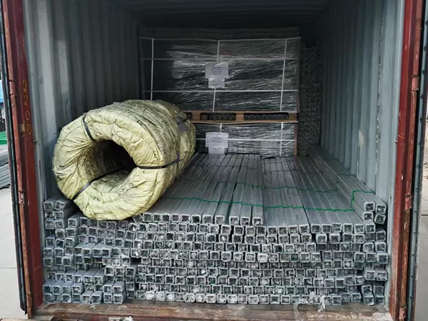 Several pieces of airport fence posts in the container.