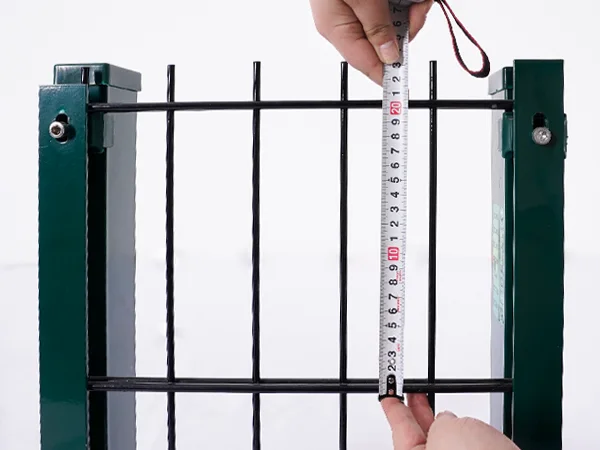 A QC worker is measuring the mesh size of 2D fence.