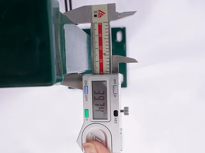 A QC worker is measuring the post size of 2D fence.
