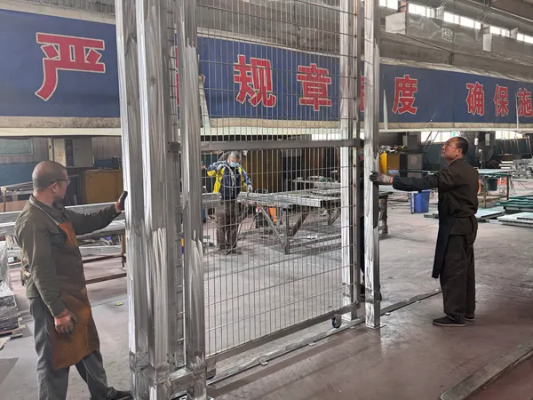Worker inspecting the sliding gate of the 2D fence system