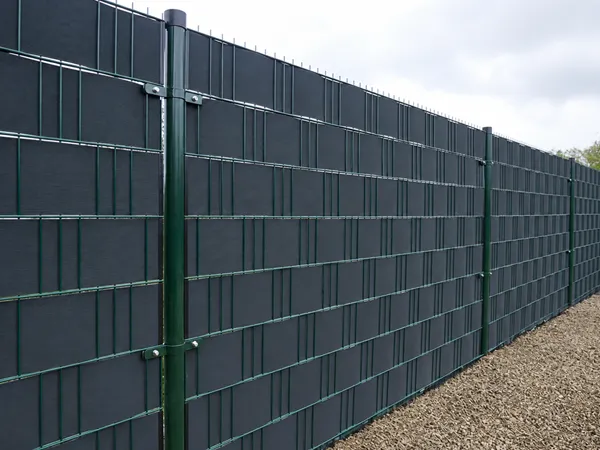 2D privacy fence with privacy slats installed along a long perimeter boundary.