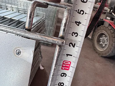 A QC worker is measuring the height of edge protection fence.