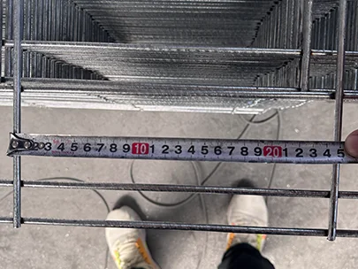 A QC worker is measuring hole size of edge protection fence.