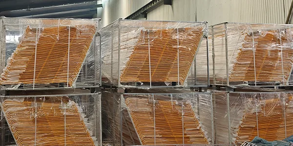Several metal pallets of yellow edge protection fences in the warehouse.