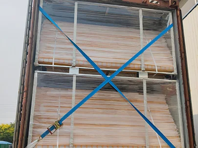 Several metal pallets of edge protection fences are in the container and fastened by the tape.
