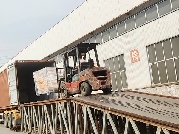 A forklift is loading the edge protection fence to the container.