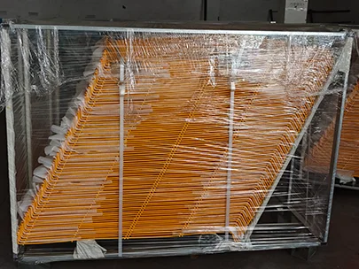 Several pieces of yellow edge protection fence are packed in a metal pallet.