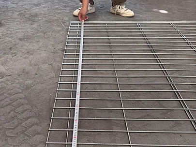 A QC worker is measuring the width of edge protection fence.