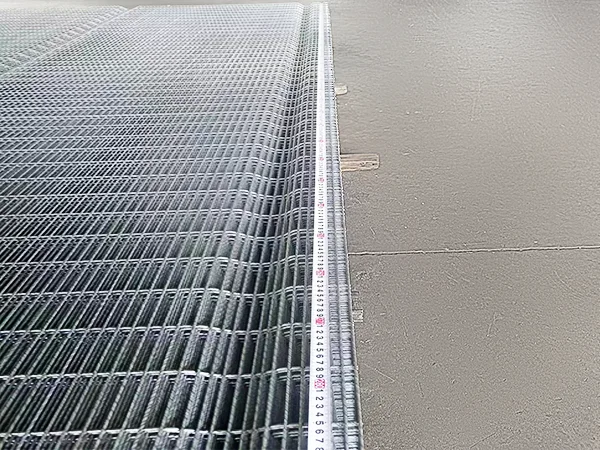 A QC worker is measuring the panel width of 358 high security fence.
