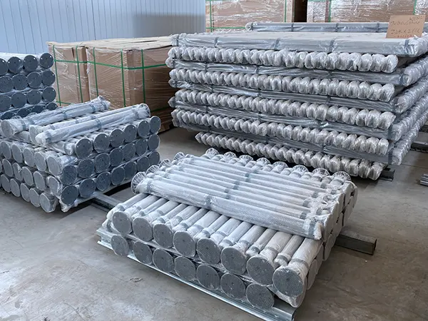 Several fence posts are placed on the ground.