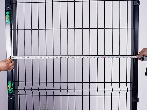 A QC worker is measuring the width of 3D fence.