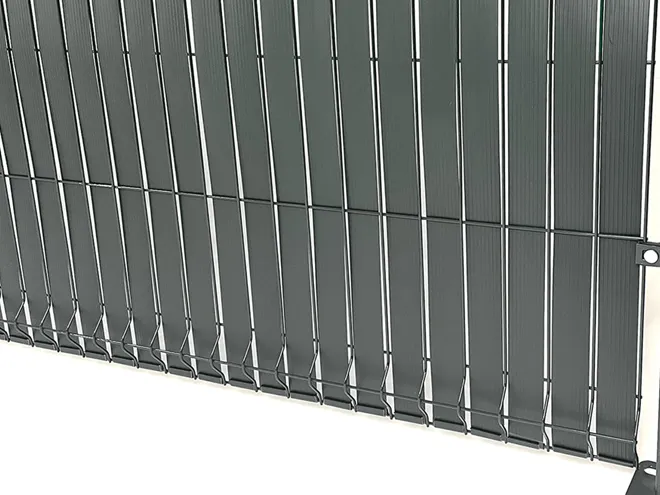 3D privacy fence with privacy tape interlaced through the wire mesh.