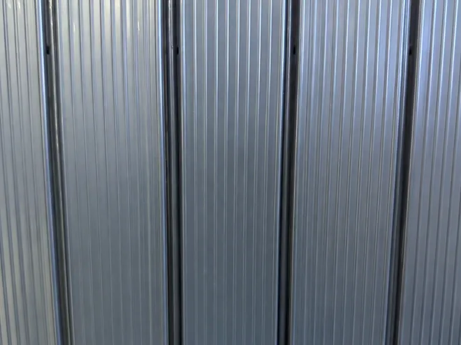 3D privacy fence with vertical privacy slats.