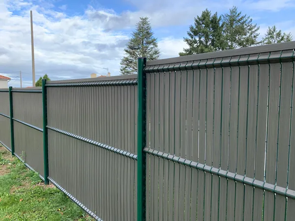 3D privacy fence with WPC privacy slats installed along a boundary.