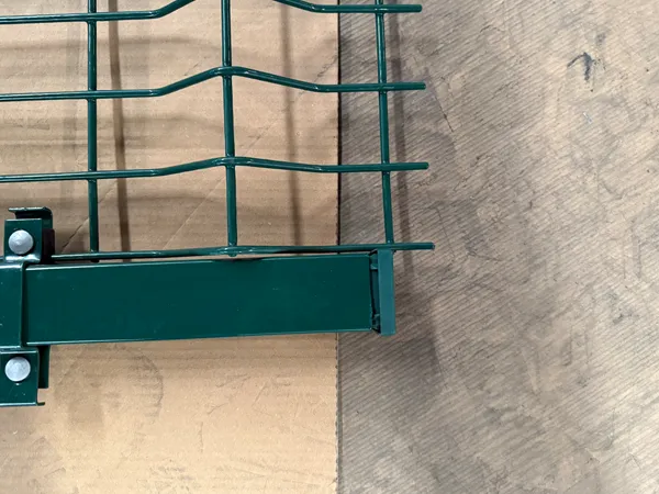 Close-up of green 3D welded mesh fence frame and fixing clamp
