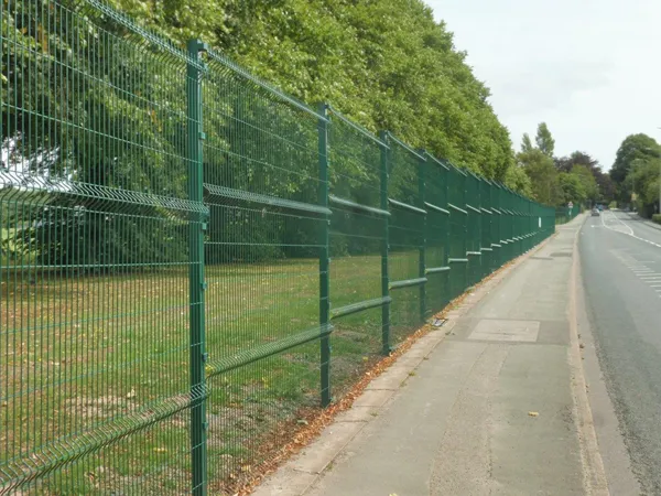 Installed green 3D welded mesh fence along roadside lawn area