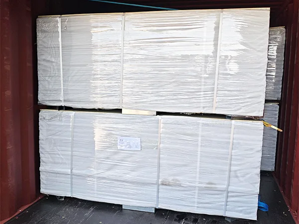 Several metal pallets of steel tubular fences in the container.