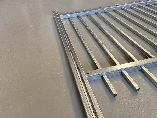 A QC worker is measuring the post height of steel tubular fence.