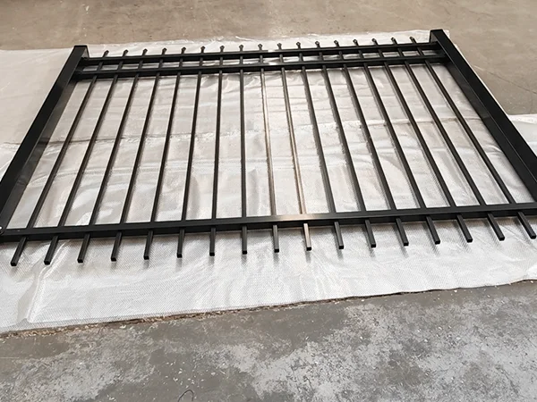 A piece of black steel tubular fence on the ground.