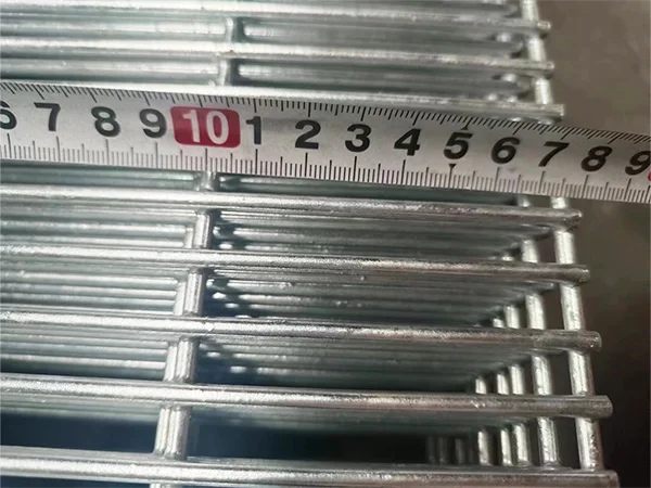 A QC worker is measuring the mesh size of High Security Fence.