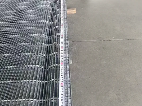 A QC worker is measuring the width of High Security Fence.