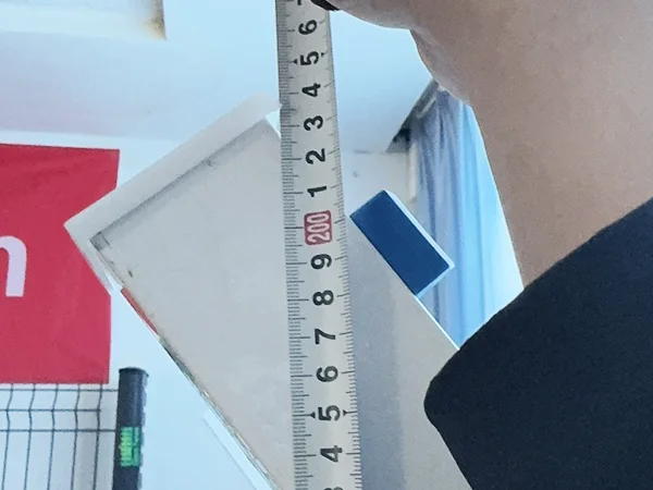 A QC worker is measuring the fence height of 3D panel type airport fence.