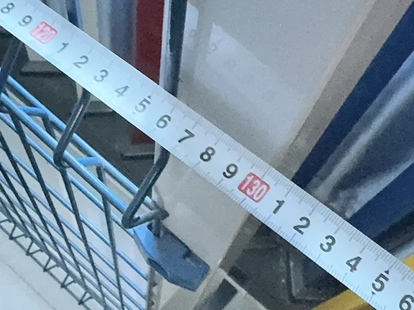 A QC worker is measuring the fence width of 3D panel type airport fence.