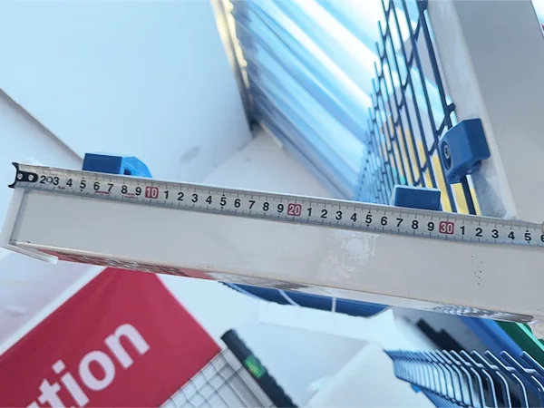 A QC worker is measuring the Y Arm length of 3D panel type airport fence.