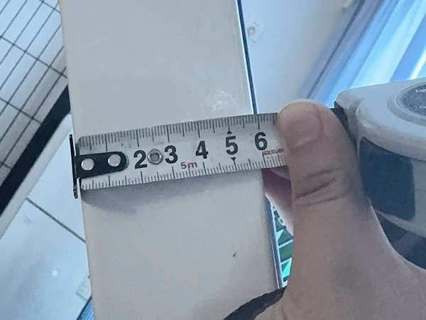 A QC worker is measuring the Y arm size of 3D panel type airport fence.