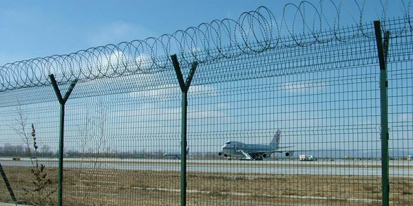 Completed airport fencing system, razor wire mesh surrounding airfield runway