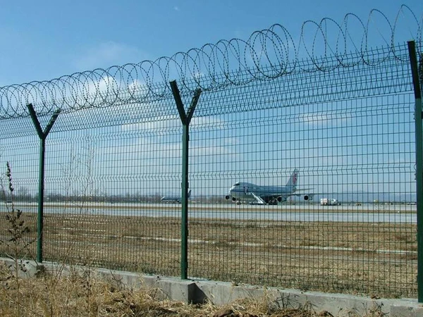 Completed airport fencing system, razor wire mesh surrounding airfield runway