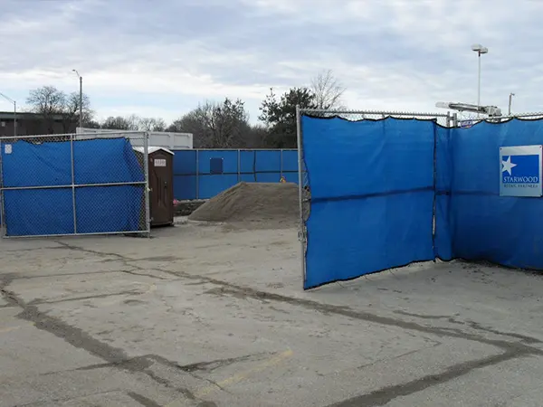 The American temporary fencing panels are installed at the building construction sites.