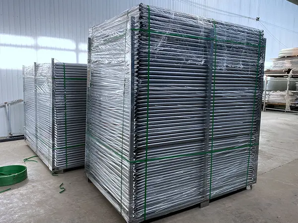 Two metal pallets of American temporary fencing panels.