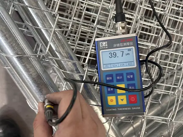 A QC worker is testing the zinc coating thickness of American temporary chain link fence.