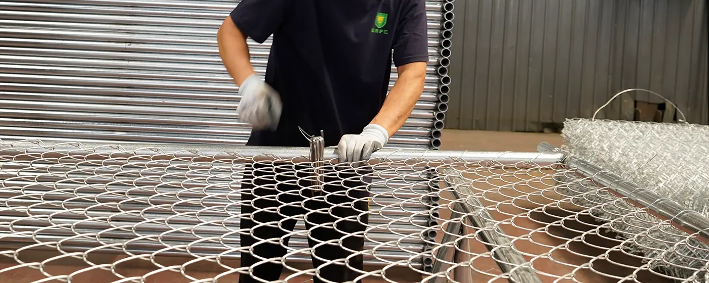 A worker is assembling American temporary fencing.