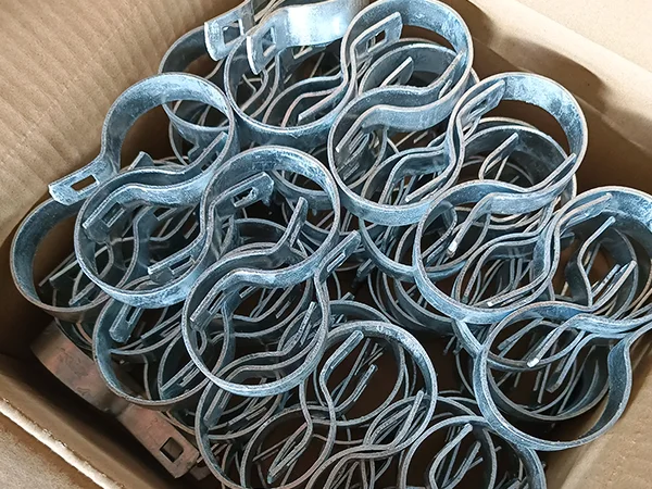 Several pieces of chain link fence fittings in the carton.