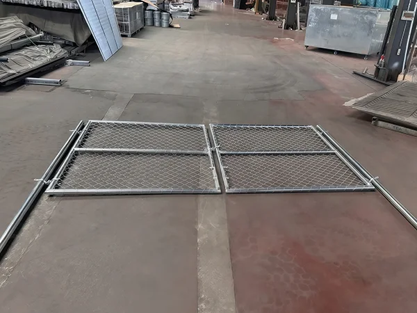 A chain link fence double gate on the ground.