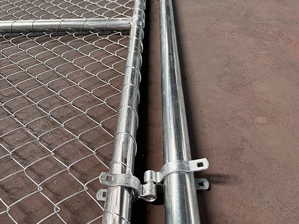 A chain link fence double gate on the ground.
