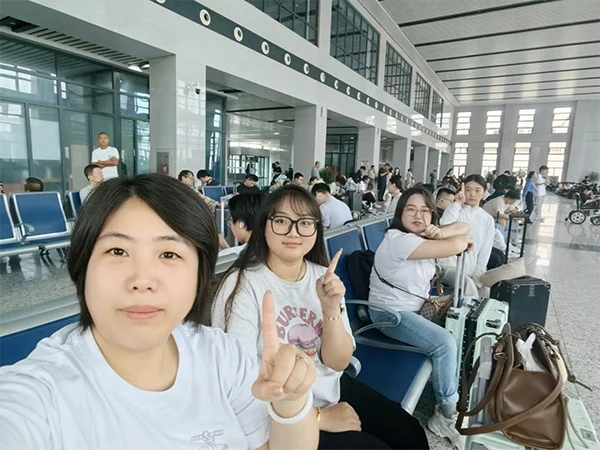 The team members are waiting for the train at railway station.