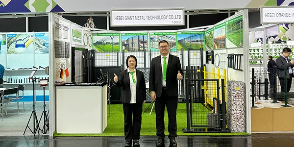 The CEO and sales manager takes photos at the front of the exhibition booth.